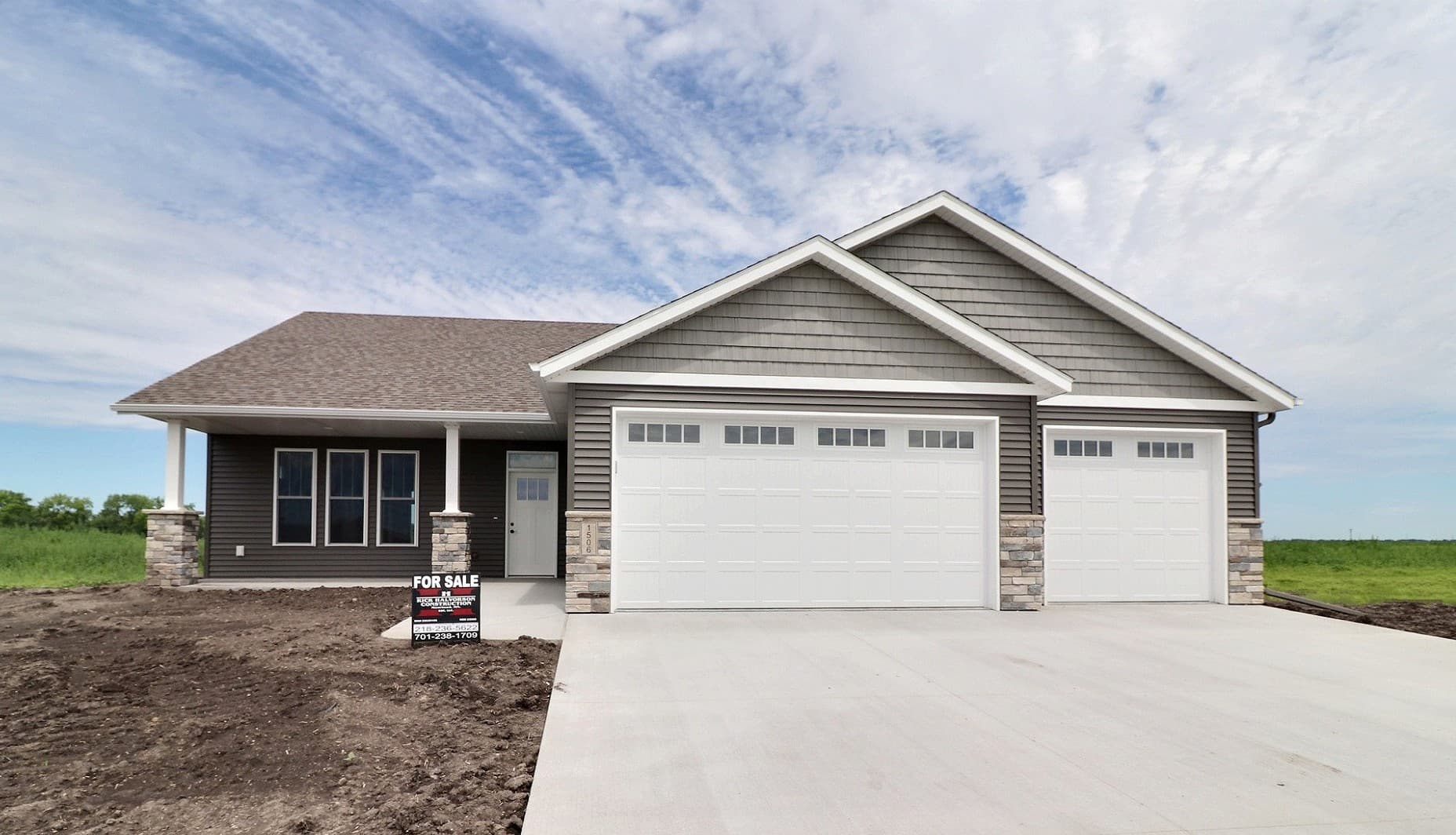 RHC-built custom ranch home with three-car garage, stone accents and shake gables in the Dilworth and Moorhead area