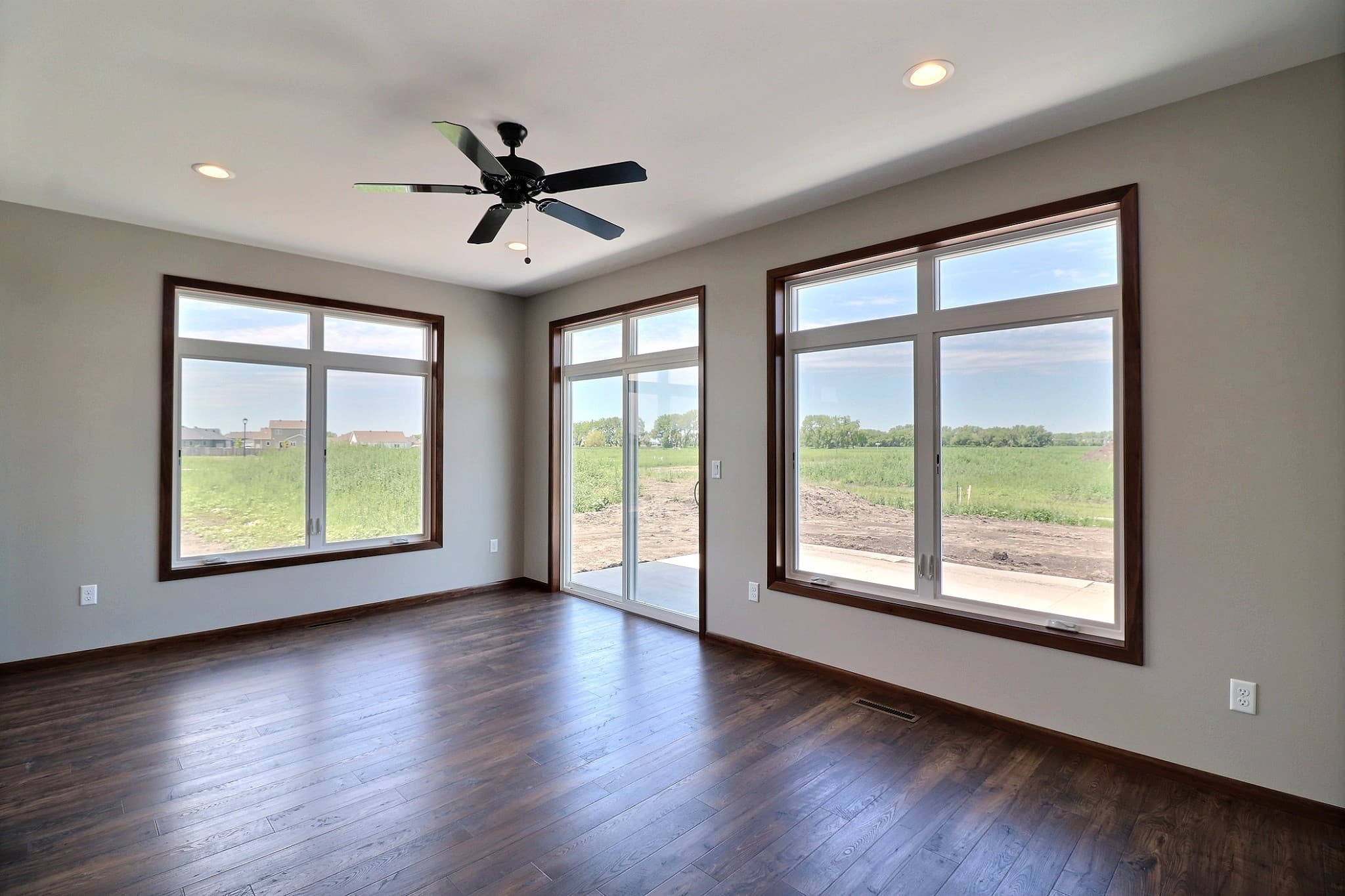 Sun-filled room with large ProVia replacement windows and a patio door